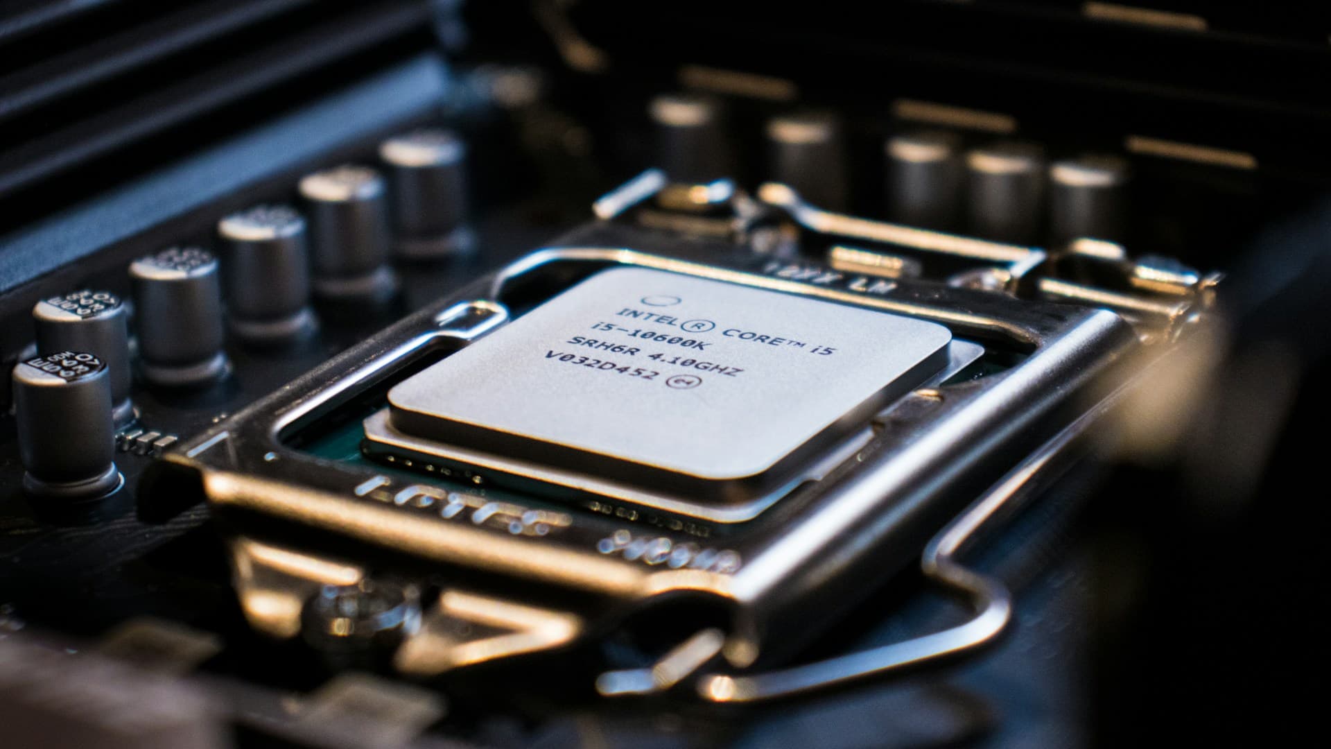 Intel Core i5 processor seated in an LGA socket on a motherboard with retention arm visible, representing a CPU upgrade