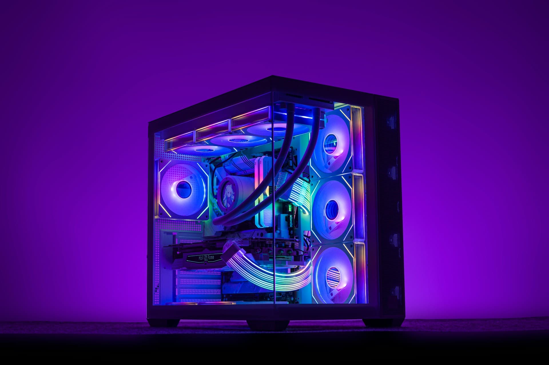 Person sitting at a gaming PC desk at night with a Samsung 980 PRO SSD, screwdriver kit, and tools laid out — preparing for a PC hardware upgrade or diagnostic
